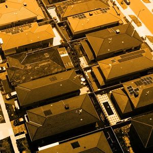 Aerial image of closely-pack suburban roof tops in an Australian city.