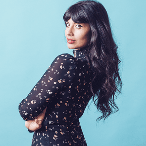 A triptych composite of a woman with long dark hair wearing a dark floral dress. She flexes her bicep, looks over her shoulder and flicks her hair.