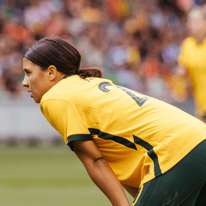 A man speaking at a lectern, a woman soccer player, a tortoise