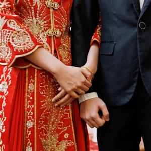 Scenes from a traditional Chinese wedding including a red jewellery box with gold jewellery, a man and woman holding hands, and a woman walking to a temple under a red umbrella