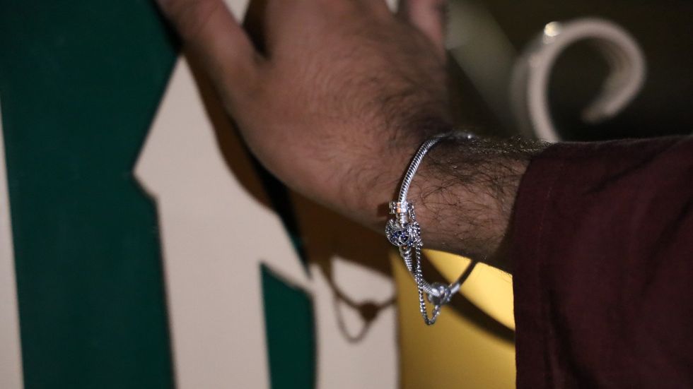 Man's arm with a silver bracelet.