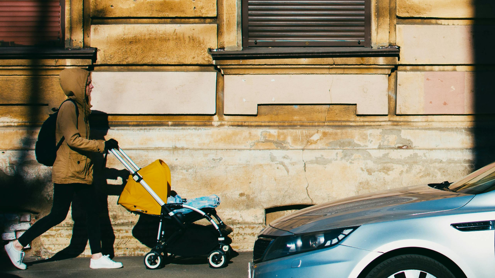 Parent pushing a baby stroller