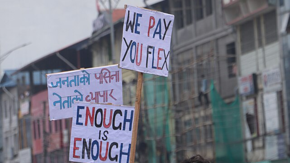 Posters reading, "we pay you flex" and "enough is enough".