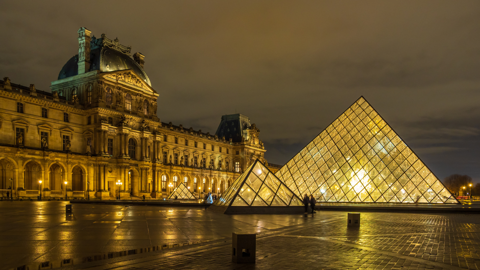 The Louvre lit up at night time