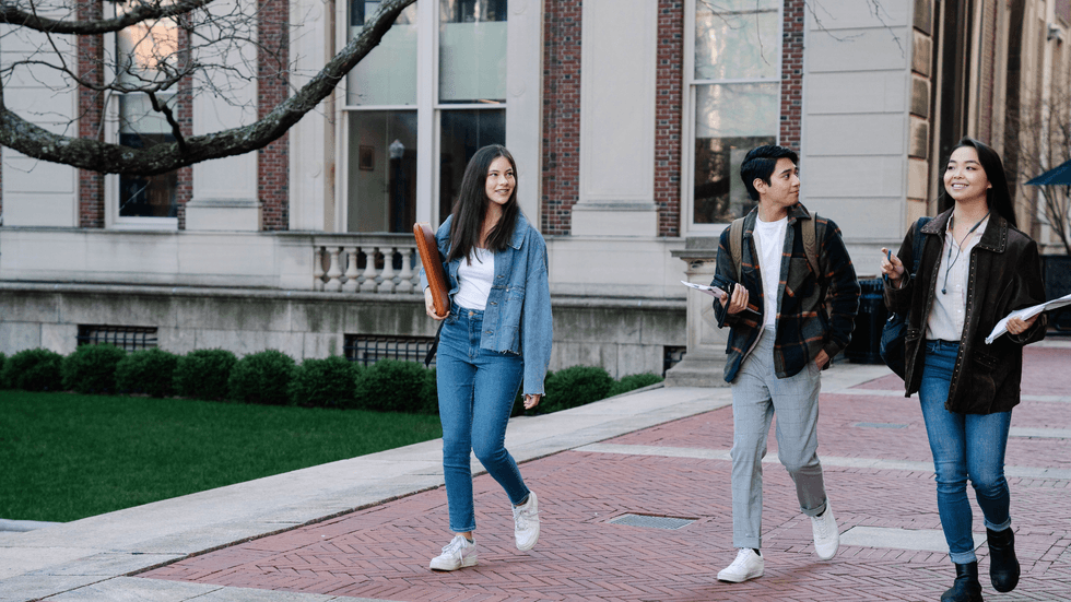Three young students on a university campus