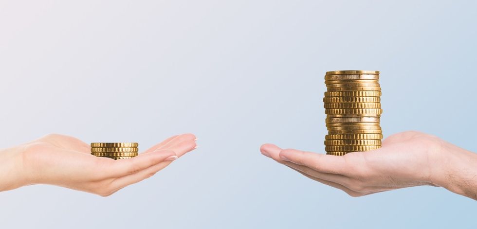 Two hands holding some coins