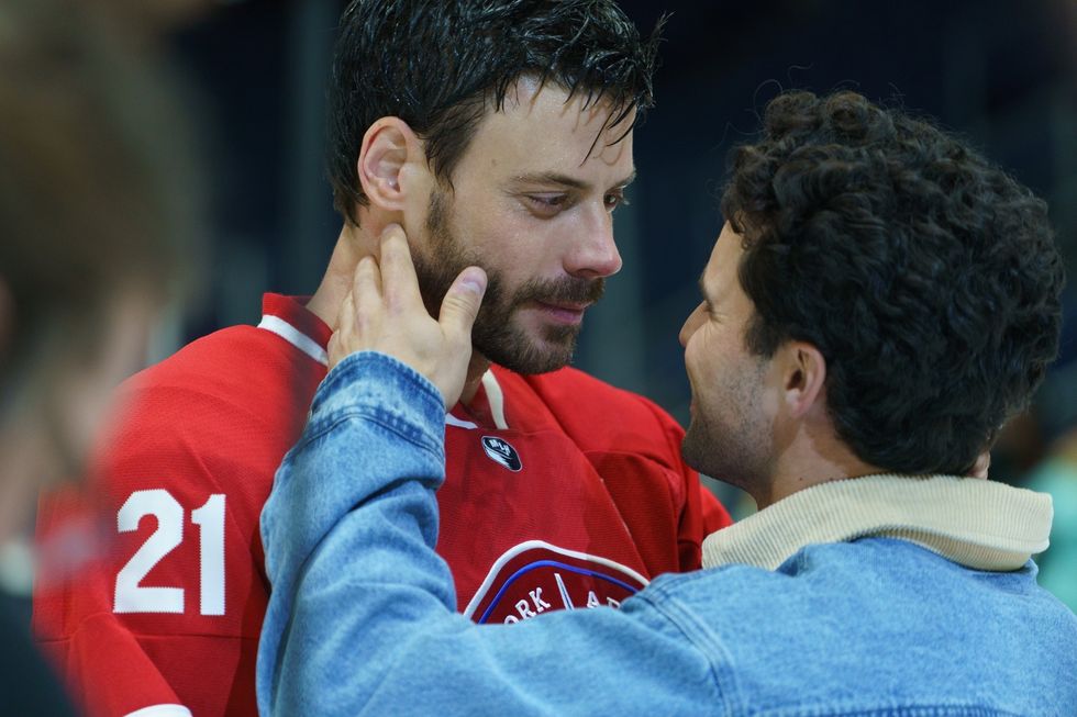 Two men embrace