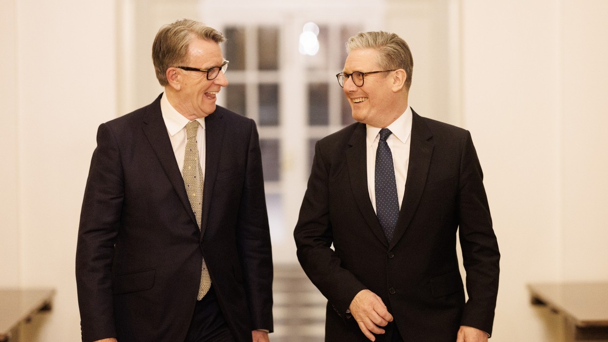 Two men in suits laughing together
