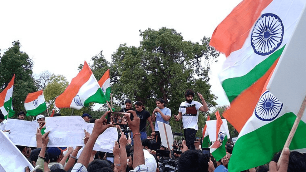 Young people holding India flags